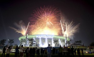 Members of Iglesia ni Cristo (Church of Christ) gather outside the Philippine Arena Dome as fireworks are set off during their 100th anniversary in Bocaue, Bulacan. AFP PHOTO