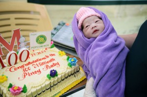 A nurse holds Jennalyn Sentino, the symbolic 100 millionth baby born at the Dr. Jose Fabella Memorial Hospital in Manila shortly after midnight on Sunday. AFP PHOTO