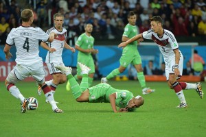 Algeria’s forward Sofiane Feghouli (center) falls to the ground as he vies for the ball against Germany’s midfielder Mesut Ozil (right), Germany’s defender and another captain Philipp Lahm (back) and Germany defender Benedikt Hoewedes during a Round of 16 football match between Germany and Algeria at Beira-Rio Stadium in Porto Alegre during the 2014 FIFA World Cup. AFP PHOTO