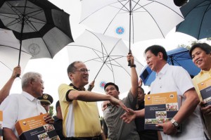 President Benigno Aquino 3rd receives a copy of the Yolanda Comprehensive Rehabilitation and Recovery Plan from Yolanda the rehab head, former senator Panfilo Lacson, at the Manila Memorial Cemetery in Parañaque City, during the commemoration of former President Cory Aquino's 5th death anniversary. PHOTO BY RUY MARTINEZ