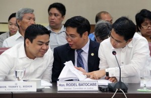 Kabataan party-list Rep. Terry Ridon (left) consults with Representatives Rodel Batocabe and Sherwing Tugna during the impeachment proceedings at the House of Representatives on Tuesday. The House committee on justice found the impeachment complaints against President Benigno Aquino 3rd sufficient in form.  PHOTO BY MIKE DE JUAN