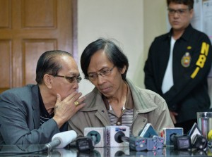 Retired general Jovito Palparan  (center), listens to one of his lawyers during a press conference shortly after his arrest, at the National Bureau of Investigation (NBI) headquarters in Manila. AFP PHOTO 