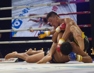 Yao Honggang celebrates his win over his opponent Jadambaa Munkhbayar (left) in their MMA bout in the Kunlun Fight tournament in Zhoukou, in China’s Henan province. AFP PHOTO