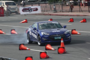 Six-time drift racing champion Alex Perez taking a guest on a sideways ride in a Hyundai Genesis Coupe.