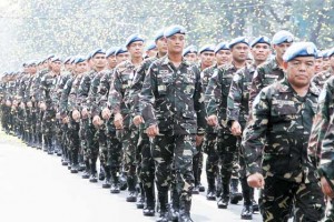  Filipino peacekeepers who recently arrived from the Golan Heights march under a shower of yellow confetti during a welcome ceremony at the armed forces headquarters in Quezon City.   AFP PHOTO 