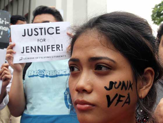 Students at UP Diliman burn the American flag to express their sympathy to the family of the slain  transgender , Jennifer Laude. Photo by Mike De Juan