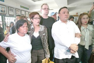 STAYING TOGETHER The mother and sister of Jeffrey “Jennifer” Laude arrive at the Olonagpo prosecutor’s office accompanied by Laude’s boyfriend Marc Sueselbeck and their lawyer. PHOTO BY RENE DILAN 