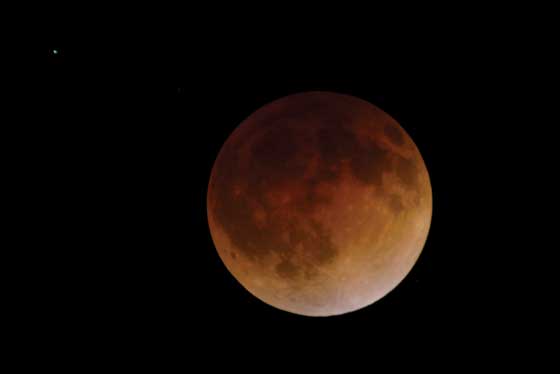 The moon appears to have an orange- red hue during a total lunar eclipse on Wednesday. A total lunar eclipse is sometimes called a blood moon because of the red color that is cast upon it by light refracting in Earth’s atmosphere. AFP PHOTO 