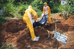 A team of funeral agents specialized in the burial of victims of the ebola virus put a body in a grave at the fing tom cemetery in freetown. AFP Photo 