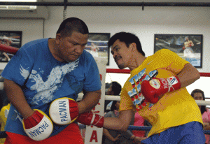 Manny Pacquiao (right) hits the mitts with assistant trainer Buboy Fernandez in General Santos City. AFP FILE PHOTO