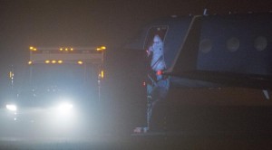 Nina Pham, 26, the first person infected with Ebola in the US, steps off the plane during a transfer at Frederick, Maryland, Municipal Airport to an ambulance en route to the National Institutes of Health (NIH) in Bethesda, on October 16, 2014 AFP - PAUL J. RICHARDS