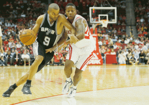 OUT OF MY WAY Tony Parker #9 of the San Antonio Spurs drives with the ball against Isaiah Canaan #0 of the Houston Rockets during their preseason game. FILE PHOTO