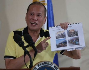 Airport Briefing  President Benigno Aquino 3rd shows the pictures of Tacloban right after it was ravaged by Super Typhoon Yolanda during a press conference in Villamor Airbase  on Friday before he left for Guiuan, Samar. PHOTO BY RENE DILAN