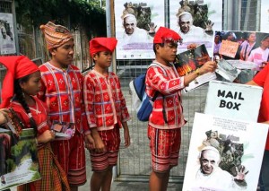 FOR THE POPE A youth from the Manobo tribe drops a postcard for Pope Francis at the Immaculate Conception Parish hall in Quezon City. The postcard and letter writing for the Pope is part of Catholic Church’s preparations for the visit of the pontiff in January. PHOTO BY MIKE DE JUAN 