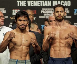 Manny Pacquiao of the Philippines (L) and Chris Algieri of the US gesture during the official weigh-in ahead of their World Welterweight Championship bout at the Cotai Arena in Macau on November 22, 2014. AFP PHOTO