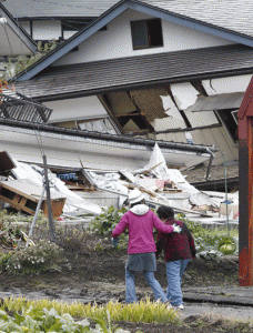 DESTRUCTION Local residents walk past a collapsed house after a strong earthquake hit the area the night before, in Hakuba, some 300 kilometers northwest of Tokyo, Nagano prefecture, on Sunday. AFP PHOTO