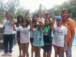 GOLD WINNERS  Philippine Swimming League President Susan Papa, Panaad swim team officers Jun Santibanez and Lori Ormeo with the gold medallists in the PSL Bacolod Leg. CONTRIBUTED PHOTO