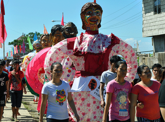 “Higantes” or giants made from papier mache (“chewed paper”) walk with revelers on Sunday during a procession as the people of Angono, Rizal province, south of Manila, celebrate the Feast of Pope Saint Clement, in part through the Higantes Festival. PHOTO BY EDWIN MULI