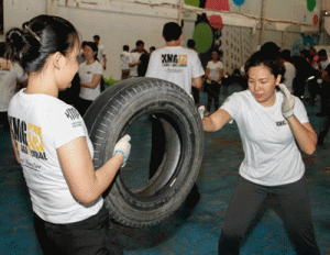 Female participants practice striking techniques on a tire. CONTRIBUTED PHOTOS