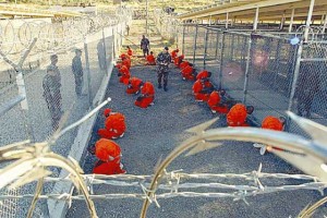 Military police process incoming Taliban and al Qaeda detainees at Guantanamo Bay’s Camp X-Ray in Cuba in 2002. (Photo by Petty Officer 1st class Shane T. McCoy/US Navy/Getty Images)