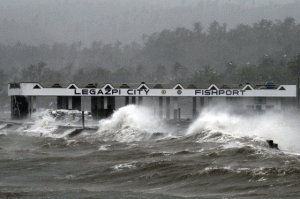 RUBY’S RAGE Huge waves brought about by strong winds pound a fishport building near Legazpi City on Sunday. Typhoon Ruby tore apart homes and sent waves crashing through coastal communities across the eastern Philippines. AFP PHOTO