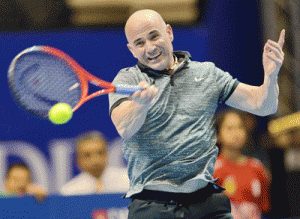 HIT! US tennis player Andre Agassi of the Singapore Slammers plays against Australian Mark Philippoussis of the Manila Mavericks during their men’s singles at the International Premier Tennis League (IPTL) competition in Singapore.