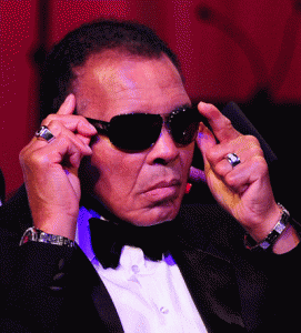 Boxing legend Muhammad Ali adjusts his glasses on stage at Muhammad Ali’s Celebrity Fight Night 18 in Phoenix, Arizona. AFP PHOTO