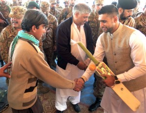 British boxer Amir Khan (right) shakes hands with an internally displaced Pakistani child, fleeing a military operation against Taliban militants in North Waziristan, as he distribute gifts during his visit to a refugee camp in Bannu. Khan, who has Pakistani roots, travelled to the troubled country to show solidarity with victims of a school attack and their families. A team of heavily armed Pakistani Taliban gunmen stormed the army-run school in the northwestern city of Peshawar last week, slaughtering 150 people including 134 children. AFP PHOTO