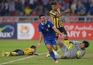 Kroekrit Thawikan of Thailand (center) celebrates after scoring during their final 1st leg football match, for the Suzuki cup 2014 at the Rajamangala stadium in Bangkok. AFP PHOTO