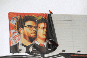 NO SHOW Workers remove a poster-banner for The Interview from a billboard in Hollywood, California on Friday, a day after Sony announced was canceling the movie’s Christmas release because of a terrorist threat. AFP PHOTO