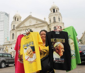 Brand ambassador  He’s everywhere, Pope Francis is, on shirts like on this one being offered for sale in front of Quiapo Church in Manila on Thursday. Look around and you’re sure to find the pontiff’s face on mugs and calendars, in key chains and ball pens, and anything that anyone with a pen or pencil can write Francis’ name. PHOTO BY MELYN ACOSTA