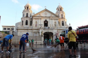 The Day After Volunteers clean up the area near Quiapo church after the image of the Black nazarene was returned to its sanctuary early saturday. Photo By MelyN AcostA