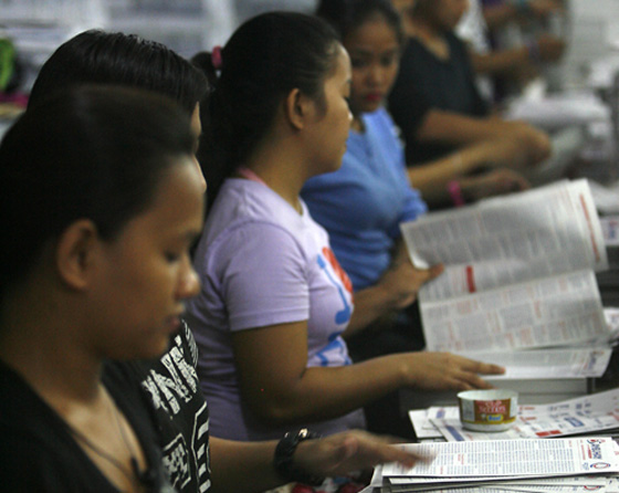 MISSALETTES IN THE MILLIONS  Workers sort missalettes for the Mass of Pope Francis at Luneta (Rizal Park in Manila) at the Abiva Publishing House in Quezon City on Wednesday. An estimated three million missalettes were printed in anticipation of the crowd attending the Mass at Luneta’s Quirino Grandstand on January 18. PHOTO BY MIGUEL DE GUZMAN 