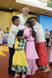 Group hug photo released by the Vatican shows Pope Francis embracing children during his encounter with the youth at the University of Santo Tomas on Sunday. AFP photo 