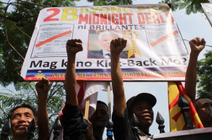 Fists of Fury Members of the National Transformation Council hold a rally in front of the Manila Cathedral to call for the junking of PCOS machines.  Photo by Melyn Santacera