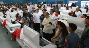  President Aquino prays before a casket bearing the remains of a fallen troop also at the wake. PHOTOS BY MALACAÑANG 