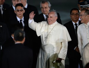 Pope Francis waves to students (not pictured) delivering a performance shortly after arriving at Villamor Airbase in Pasay City on Thursday. AFP PHOTO