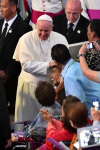 Pope Francis blesses a sick boy as he arrives to a meeting with families in Manila on Friday. AFP PHOTO 