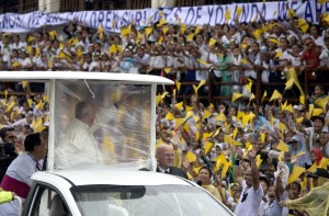 Pope Francis waves towards children who survived of Typhoon Yolanda, as he arrives at the Palo Cathedral in Palo, Leyte, on Saturday. Pope Francis braved heavy rain on January 17 to celebrate an emotional mass with a sea of weeping survivors of the super typhoon that killed thousands, saying their pain silenced his heart. AFP PHOTO 