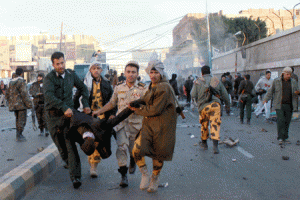 DEADLY BLAST  Yemeni security forces remove a body from the site of a car bomb explosion outside the police academy in the capital Sanaa on Wednesday. The attack struck as dozens of Yemenis queued to join the police academy in central Sanaa. AFP PHOTO