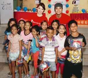 Kylie Padilla and Mikael Daez with some of the students they taught for a day at a public school in Calo