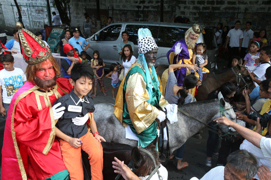 Men dressed as the Three Kings amuse the crowd during a parade in Manila. The Feast of he Three Kings marks the end of the Christmas in the Philippines, known to have the longest Christmas season. PHOTO BY RENE DILAN