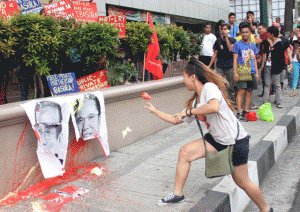 SEEING RED  A student throws paint at a photograph of Transportation Secretary Emilio Abaya during a rally in Pasig City. PHOTO BY MIKE DE JUAN