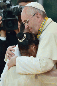 SPECIAL HUG Pope Francis embraces Glyzelle Palomar and another child during his encounter with the youth at the University of Santo Tomas. AFP PHOTO