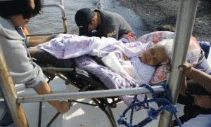 SEA RESCUE  A 79-year-old grandmother, who suffered a heatstroke while on vacation, is being transported by sea ambulance from Mariveles in Bataan province to Cavite. Professionals also gave her medical attention while being brought to the nearest hospital. PHOTO BY ROGELIO LIMPIN