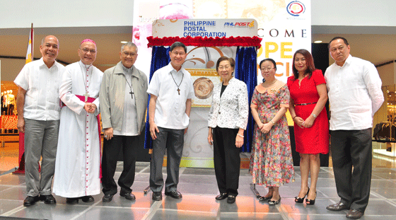 His Eminence Cardinal Luis Antonio Tagle (fourth from left), PHLPost Chairman Cesar Sarino (right) and Postmaster General and CEO Ma. Josefina dela Cruz (second from right), and Felicidad Sy (fourth from right) at the Pope Francis Special Coinage Stamp exhibit launch at The Block. Also in photo are (from left) Archbishop Romulo Valles of Davao, Bishop Honesto Ongtioco of Cubao, Archbishop Angel Lagdameo of Jaro, Iloilo, and 51st International Congress Committee on PR Chairman Elvira Yap Go (third from right)