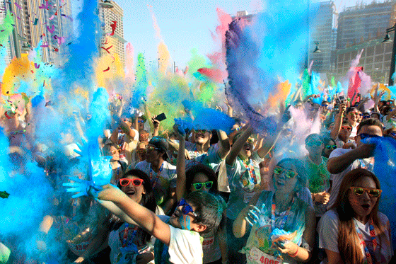 Joggers throw colored powder and confetti during the Color Fun Run in Taguig City on Sunday. The annual event aims to promote a healthier lifestyle among the youth. PHOTO BY MIGUEL DE GUZMAN