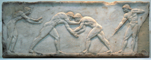 MAN’S OLDEST SPORT A Greek relief sculpture depicting two nude wrestlers. PHOTO FROM WIKIPEDIA