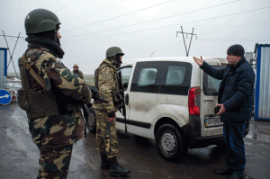 TENSE SITUATION Ukrainian troops check passengers of a car at a checkpoint in the eastern Ukrainian city of Kurakhove, near Donetsk on Thursday. Heavy fighting raged between Ukrainian forces and pro-Russian rebels in the country's war-torn east Wednesday, ahead of high-stakes peace talks in Berlin. AFP PHOTO