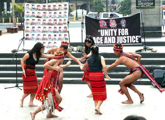 Indigenous students perform a ritual dance in manila near a display of photos of the 44 special action force commandos slain in mamasapano, maguindao.  PHoto By Rene Dilan